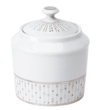 A white Limoges porcelain sugar bowl with lid from the Philippe Deshoulieres Carrousel Dinnerware, featuring geometric gold and silver patterns along the base and lid.