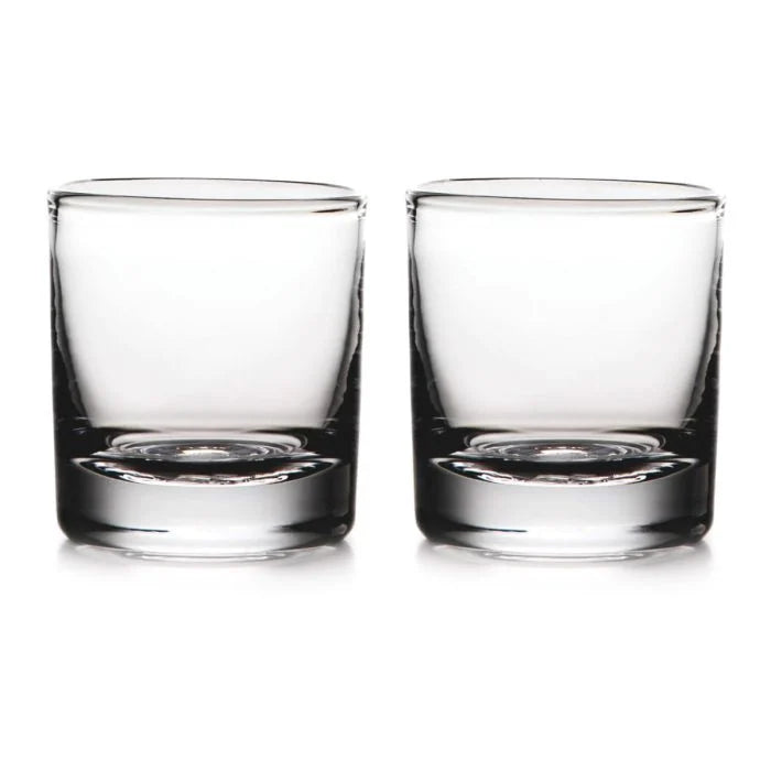 Two empty, clear Simon Pearce Ascutney Double Old Fashioned glasses are placed side by side on a white background, highlighting this elegant set of 2.