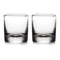 Two empty, clear Simon Pearce Ascutney Double Old Fashioned glasses are placed side by side on a white background, highlighting this elegant set of 2.