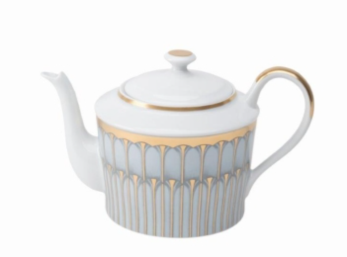 A white porcelain teapot from Philippe Deshoulieres’ Arcades Gold Dinnerware features gold and gray geometric patterns, a gold-rimmed lid, and a gold-accented handle, shown on a plain white background.