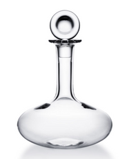 The Baccarat Oenologie Decanter by Baccarat features a clear crystal body with a wide, round base, tall neck, and spherical stopper, inspired by the Oenologie design. Shown against a plain white background.
