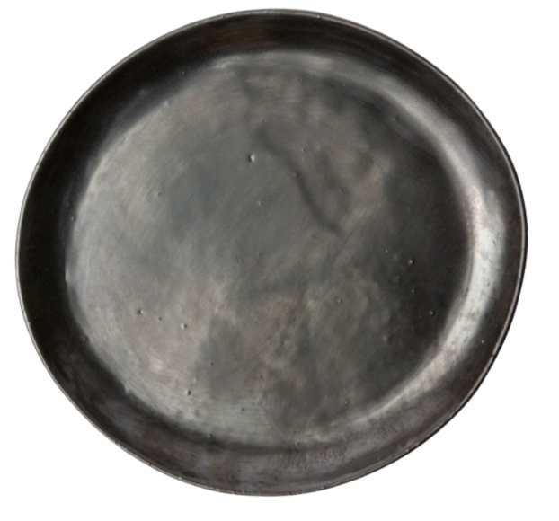 The Marcus Black Dinnerware Set of 4 by Blue Pheasant features round, dark gray stoneware plates with a subtly uneven surface and minor indentations, highlighting the brand’s signature organic silhouettes. Shown on a white background.