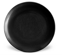 A round, plain black ceramic plate with a subtle matte texture from L'Objet's Terra Iron Dinnerware collection, displayed on a white background.