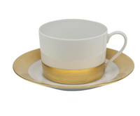 The Danielle Gold Dinnerware teacup and saucer by Royal Limoges feature elegant white porcelain with gold accents, crafted in France and shown against a plain white background.