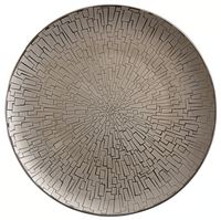 The Skin Platinum TAC 02 Dinnerware by Rosenthal features a round metallic plate with platinum accents and a geometric, maze-like starburst pattern, reflecting fine German porcelain craftsmanship.