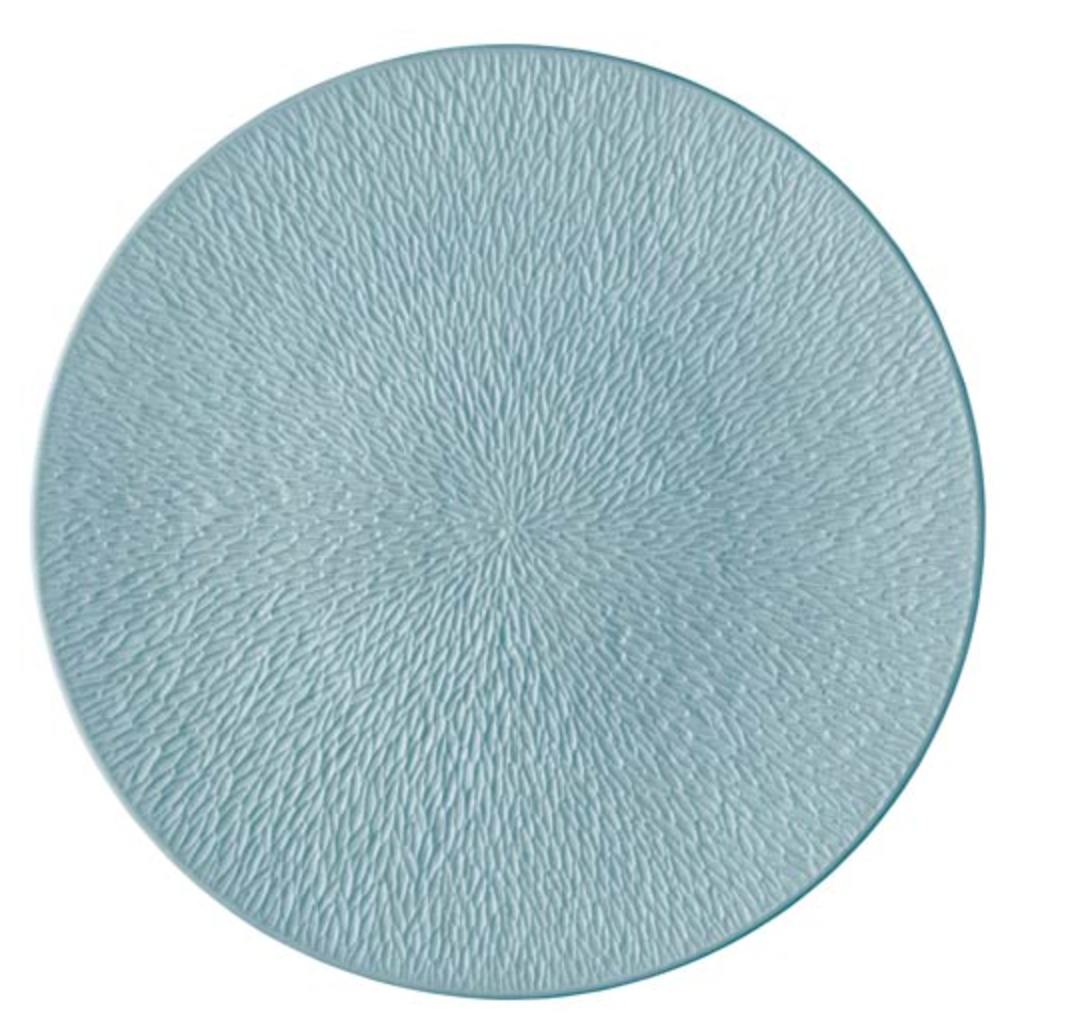 A round Mineral Irise Dinnerware Sky Blue plate by Raynaud, featuring a textured radial pattern in light blue Limoges porcelain, made in France, shown from above on a white background.