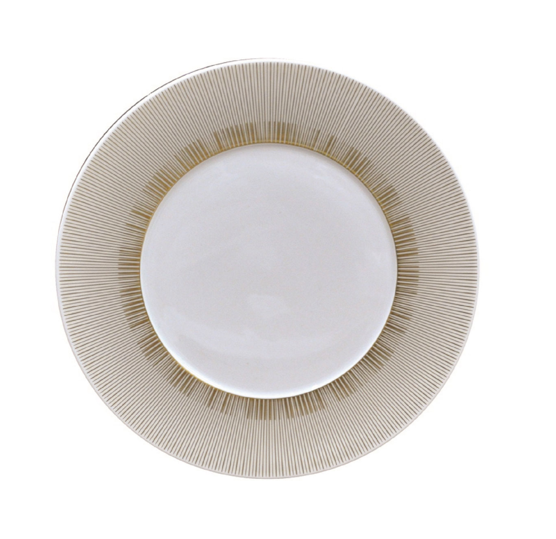 The Sol Dinnerware by Bernardaud is a white ceramic plate featuring a 24k gold radial line pattern around the rim, shown from above on a white background.