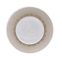 The Sol Dinnerware by Bernardaud is a white ceramic plate featuring a 24k gold radial line pattern around the rim, shown from above on a white background.