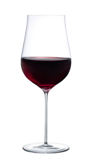 A Ghost Zero Tulip Glassware by Nude Glassware, handmade and filled halfway with red wine, stands upright on a white background.