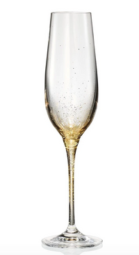 A clear champagne flute from the Kim Seybert Orion Gold Barware Set of 4 features hand-sprayed gold accents at the base and lower bowl, shown against a plain white background.