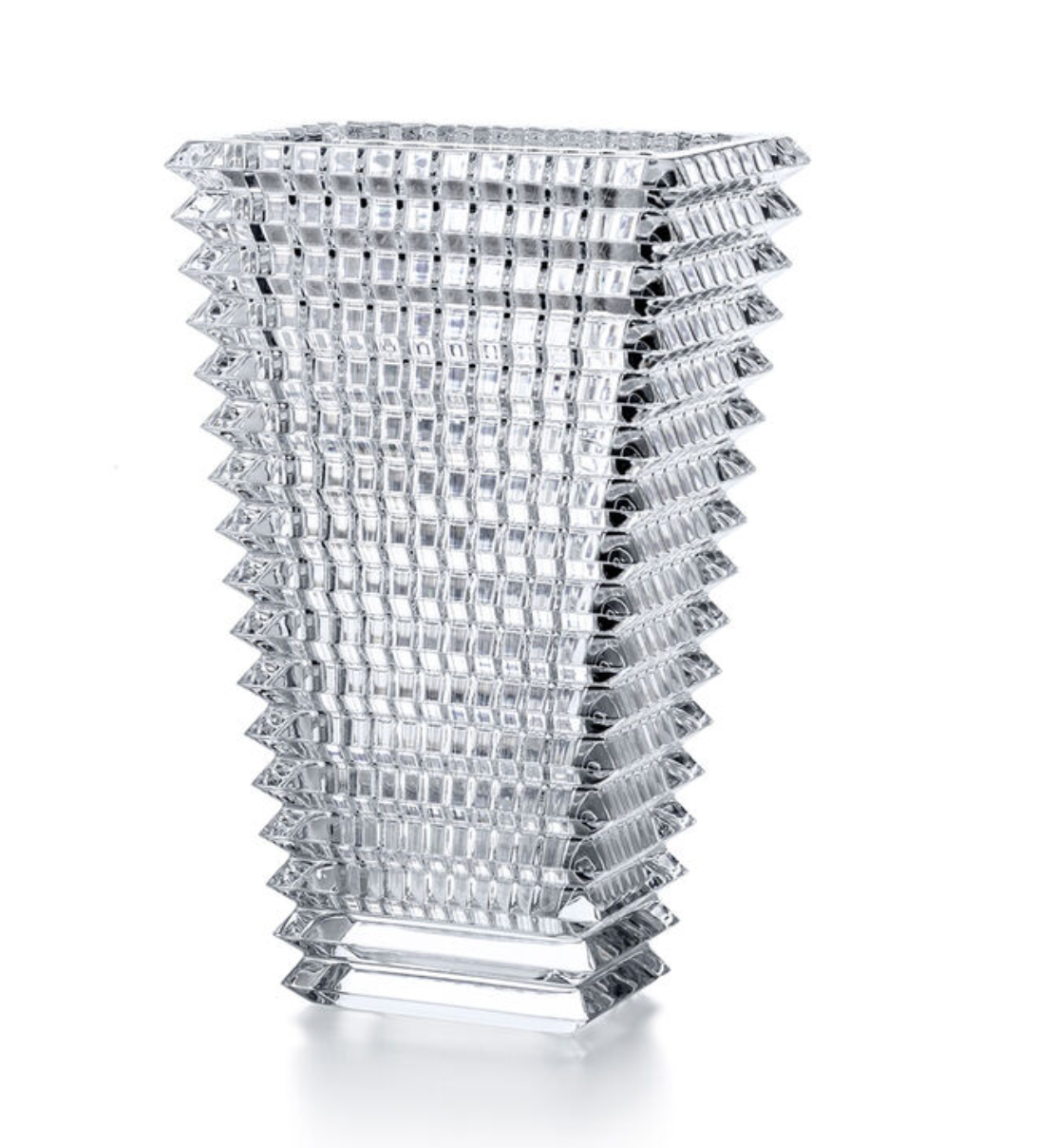 The Baccarat Eye Rectangular Vase Clear features a geometric design with a square base, a flared top, and textured raised squares creating a striking grid-like pattern along its sides.
