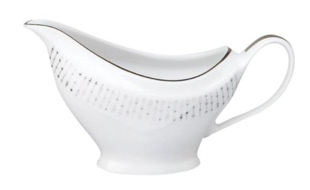 The Carrousel Dinnerware gravy boat by Philippe Deshoulieres is crafted from white Limoges porcelain, featuring a delicate silver pattern, thin platinum rim, elegant handle, and curved spout.