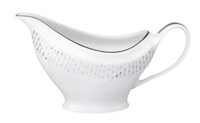 The Carrousel Dinnerware gravy boat by Philippe Deshoulieres is crafted from white Limoges porcelain, featuring a delicate silver pattern, thin platinum rim, elegant handle, and curved spout.