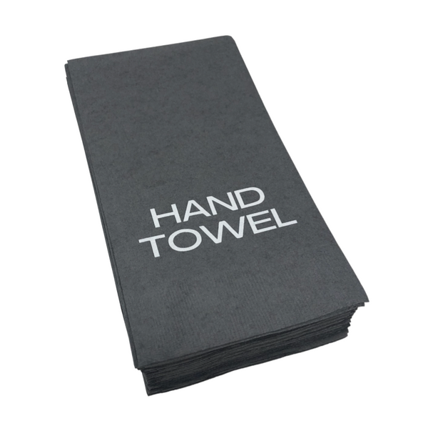 A stack of folded pewter guest hand towels by Print Appeal, each with "HAND TOWEL" in bold white letters—ideal for display in an acrylic guest towel holder.