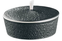 A textured, round dark gray ceramic container with a matching lid and white handle by Raynaud, ideal for pairing with Mineral Irise Dinnerware - Black or accenting modern table settings.