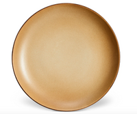 The L'Objet Terra Leather Dinnerware plate features a round shape, tan color with a subtle gradient, and glazed finish, shown against a white background.