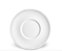 The Soie Tressée White Dinnerware by L'Objet features a plain white French dinner plate with a subtle braided rim pattern, displayed against a white background.