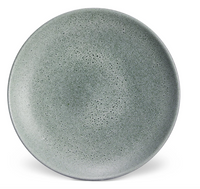 A round, speckled grey plate with a matte finish from L'Objet’s Terra Seafoam Dinnerware collection, featuring exquisite handcrafted design.