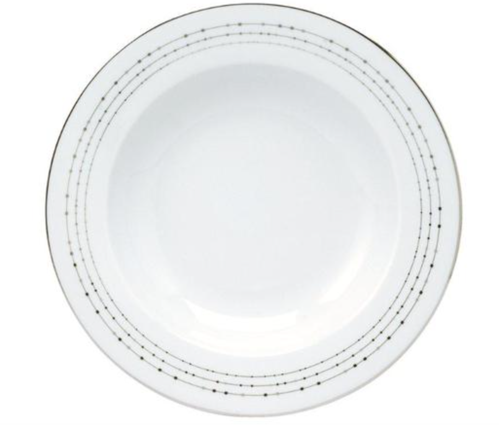 The Carrousel Dinnerware by Philippe Deshoulieres is a white ceramic plate with a slightly raised rim and thin dotted lines circling the edge, evoking the elegance of platinum-trimmed dinnerware.
