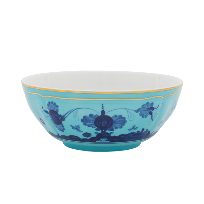 The Oriente Italiano Dinnerware Iris by Ginori 1735 is a turquoise ceramic bowl with blue chinoiserie floral motifs and a gold rim, reminiscent of exquisite Italian porcelain.