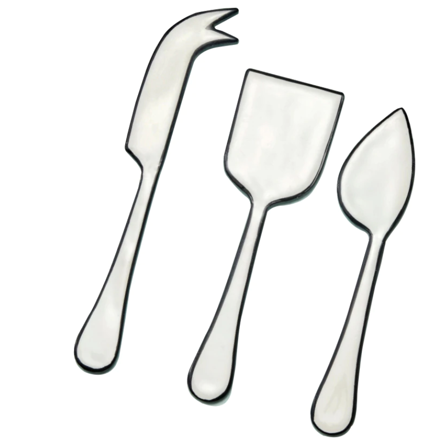 The Be Home Outline Enamel Cheese Set features three elegant utensils—a fork-tipped knife, flat spatula, and pointed spreader—on a white background. Handwash recommended to maintain the enamel finish.