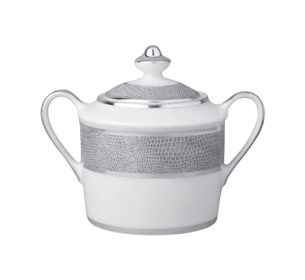 The Bernardaud Sauvage Grey & Platinum sugar bowl features white Limoges porcelain with two handles, a lid, and a platinum snake skin embossed band—offering elegant refinement to any dinnerware collection.