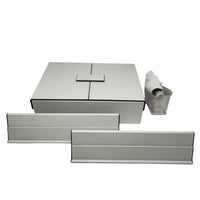 The Brouk & Co Excelsior Rummikub Set Silver features light gray rectangular storage boxes and trays with black edges—a large leather lidded box, two slim trays, and a rolled-up pouch—all displayed on a white background.