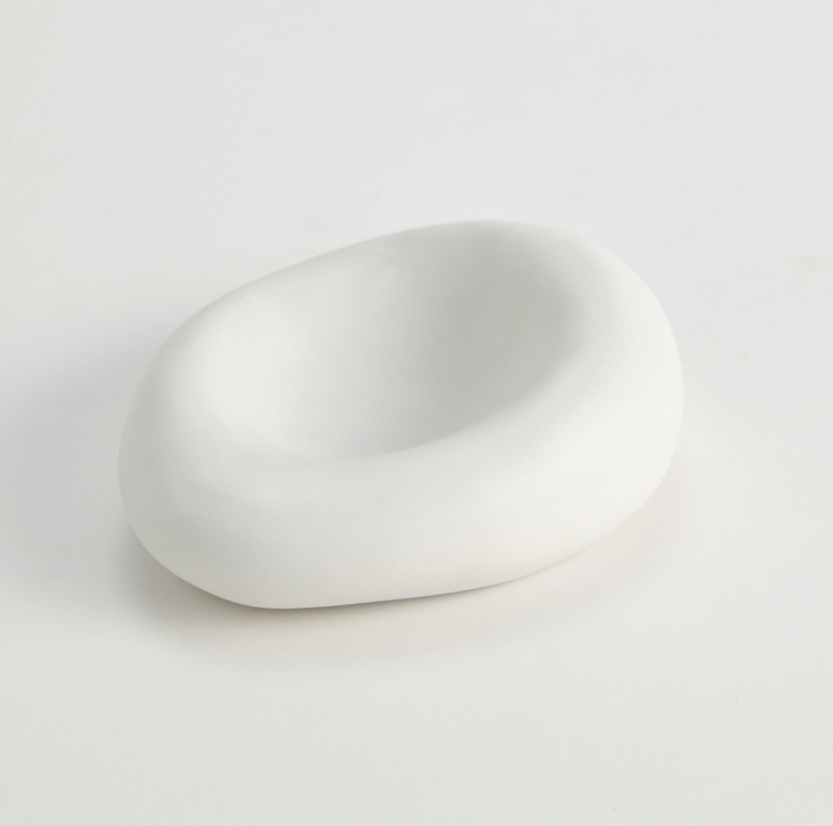 The Balloon Bowl White by Global Views/Surya is a small, matte white, oval-shaped bowl with a smooth, asymmetrical form, Italian crafted and displayed on a plain white surface.