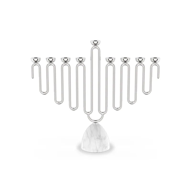 The Coluna Menorah Carrara Marble & Silver by Anna New York features a striking geometric, wavy design with eight silver branches set atop a smooth Italian Carrara marble base. Photographed against a plain white background, this modern menorah seamlessly blends contemporary style with timeless elegance.