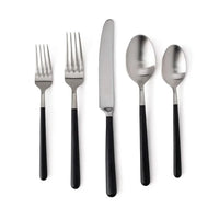 The Simon Pearce Hampton Flatware 5 Piece Setting features stainless steel and black resin handles—includes two forks, a knife, a tablespoon, and a teaspoon—shown side by side on a white background.