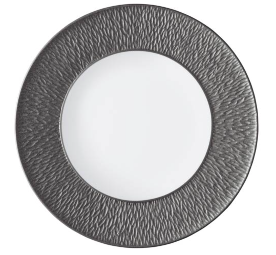 The Raynaud Mineral Irise Dinnerware Dark Grey dinner plate, crafted in France from Limoges porcelain, features a smooth white center and a wide dark gray rim with a wavy textured pattern for elegant, refined dining.