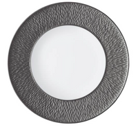 The Raynaud Mineral Irise Dinnerware Dark Grey dinner plate, crafted in France from Limoges porcelain, features a smooth white center and a wide dark gray rim with a wavy textured pattern for elegant, refined dining.