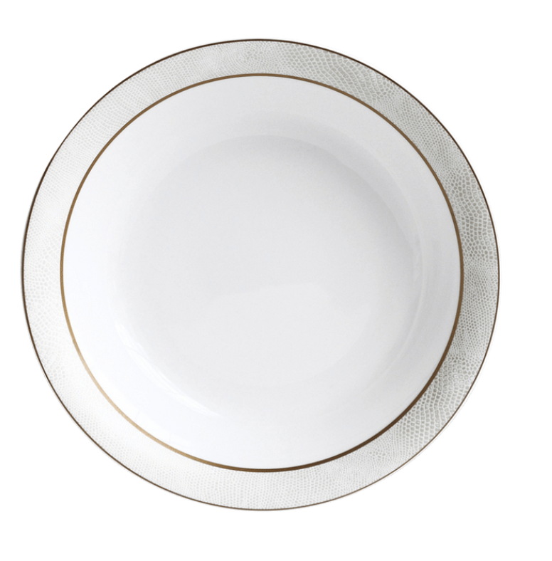 The Sauvage Gold Dinnerware by Bernardaud features a round white Limoges porcelain plate with an embossed snakeskin-textured rim and a slim gold band, shown from above on a white background.