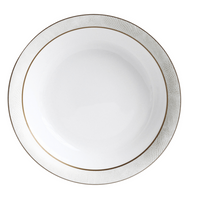 The Sauvage Gold Dinnerware by Bernardaud features a round white Limoges porcelain plate with an embossed snakeskin-textured rim and a slim gold band, shown from above on a white background.