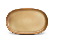 The L'Objet Terra Leather Dinnerware features a large, empty, oval-shaped ceramic plate with a light brown gradient glaze, displayed against a white background.
