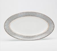 The Makassar Gray & Platinum Dinnerware by Royal Limoges/Bia Cordon Bleu is an oval porcelain plate handmade in France, featuring a gray and white textured rim with a platinum accent on a white background.