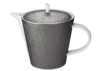 The Raynaud Mineral Irise Dinnerware Dark Grey Teapot features a textured, dark grey ceramic body and lid made in France. Smooth white handle, spout, and rim provide contrast, while a small vertical white handle tops the lid for easy lifting.