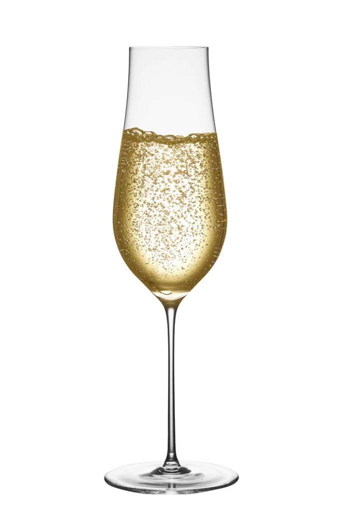 The Ghost Zero Tulip Glassware by Nude Glassware is a tall, slender champagne flute made from lead-free crystal, filled with sparkling golden champagne and rising bubbles, set against a plain white background.