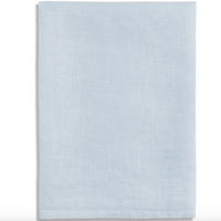 The L'Objet Linen Sateen Napkin Light Blue Set of 4, crafted from 100% linen in Portugal, is shown neatly folded against a white background.