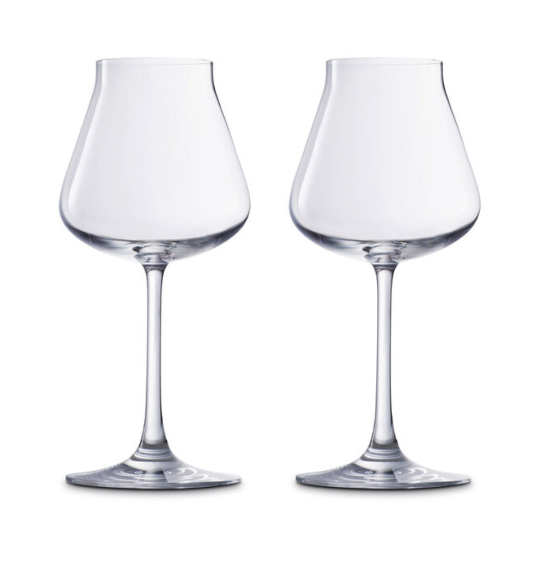 Two Baccarat Chateau Barware crystal wine glasses with wide bowls and slender stems are placed side by side against a white background, showcasing French elegance and craftsmanship.