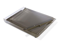 The Apeloig Solid Acrylic Challah Board & Knife features a modern, rectangular design with a dark, translucent surface and a ridged handle for easy sliding or stacking.