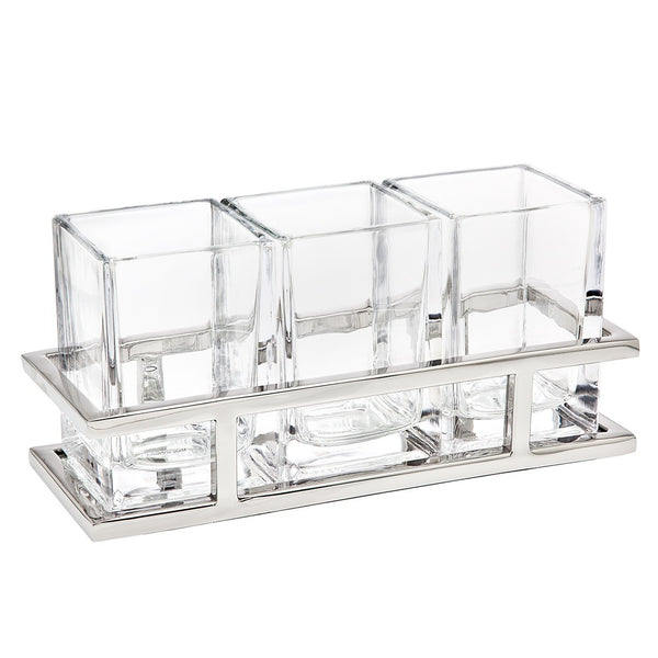 Three clear square glass containers are arranged side by side in a sleek, rectangular silver holder, making The Aspen Flatware Caddy by Godinger the perfect addition to any modern table setting.