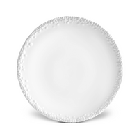 A Haas Mojave White Dinnerware ceramic plate by L'Objet features a textured beaded edge and is shown from above on a white background.