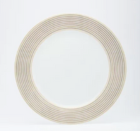 The Latitudes Dinnerware by Royal Limoges is a round white porcelain plate with fine gold stripes forming concentric circles on the rim, set against a plain white background.
