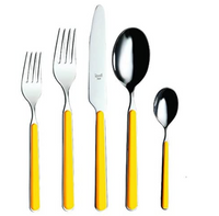 The Mepra Fantasia Flatware 5 Piece Set in yellow features two forks, a knife, a spoon, and a teaspoon with shiny metal heads and resin handles, displayed side by side on a white background.