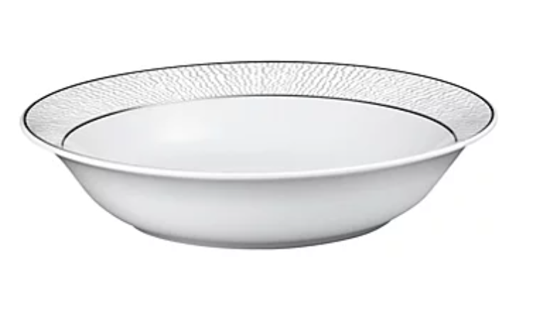 The Dune Dinnerware by Bernardaud is a white, shallow Limoges porcelain bowl featuring a textured, leaf-inspired pattern and a slim black rim, displayed on a plain white background.
