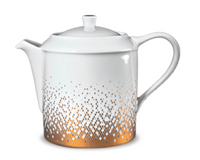 The Haviland Souffle D'or Dinnerware teapot is crafted from white Limoges porcelain, with a curved handle and spout, a lid, and a gold dotted gradient pattern at the base.
