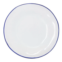 The Vietri Aurora Edge Dinnerware is a round, white ceramic plate with a thin, slightly uneven blue rim, handmade in Italy and shown from above on a plain white background.