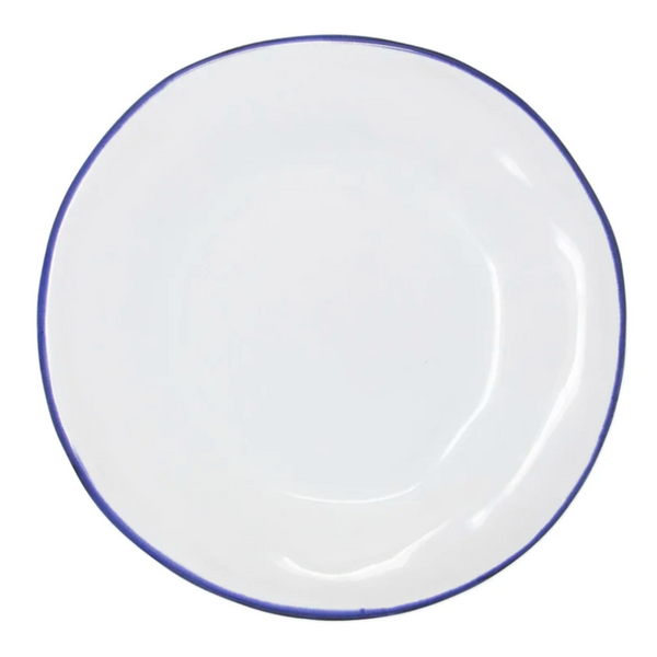 The Vietri Aurora Edge Dinnerware is a round, white ceramic plate with a thin, slightly uneven blue rim, handmade in Italy and shown from above on a plain white background.