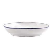 The Vietri Aurora Edge Dinnerware bowl is a shallow, round white stoneware piece with a slightly wavy edge and thin blue rim. Chip-resistant and handmade in Italy, it's displayed against a plain white background.